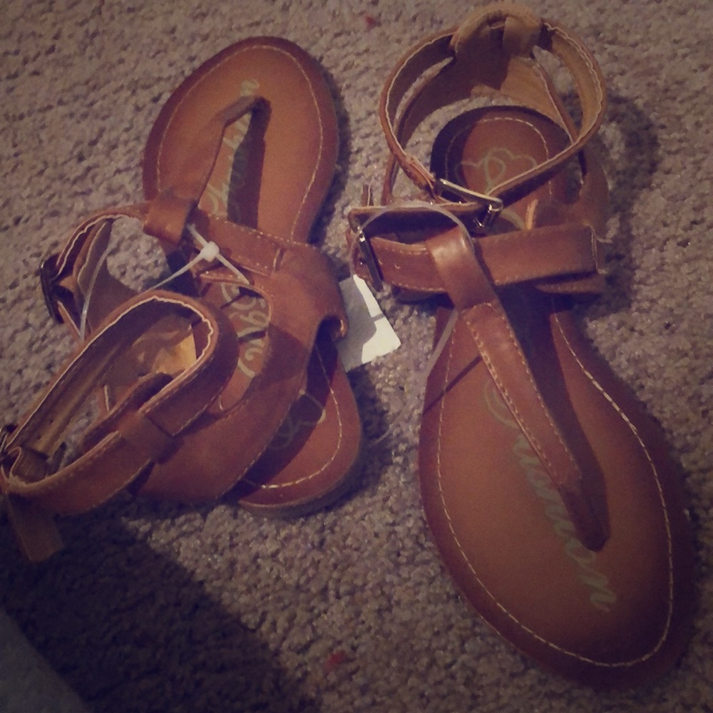 Brown sandals with strap that wraps around ankle